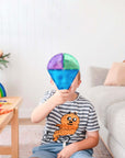 Child holding a colorful piece from the Rainbow Shape Expansion Pack 36 pc, enhancing creativity and play.
