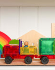 Colorful truck built with the Rainbow Motion Pack 24 pc driving on a road with a rainbow and fun shapes.