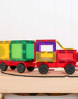 Rainbow Motion Pack 24 pc showcasing a colorful truck build with wheels and connectors on a wooden table.
