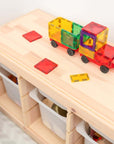 Rainbow Motion Pack 24 pc truck toy built with colorful transparent shapes on a wooden bench.