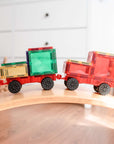 Two colorful toy trucks made with the Rainbow Motion Pack 24 pc, showcasing movement and STEM creativity.