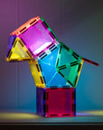 Colorful construction of Connetix Light Star Pack 28 pc tiles glowing under light.