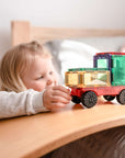 Child playing with Rainbow Motion Pack 24 pc building truck toy, showcasing creativity and STEM learning.