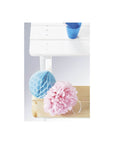 Decorative blue and pink paper decorations on a wooden picnic bench, enhancing outdoor children's play area.