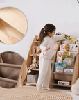 Goodevas 2-in-1 Bookshelf & Toy Storage Unit with child exploring books and soft toy storage.