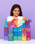 Child playing with the Glitter Castle Pack 48 pc, building a colorful and sparkling castle with glitter-infused tiles.