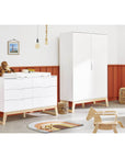 Wardrobe 'Bridge' in a child's room, featuring white MDF finish with solid ash accents and storage solutions.