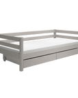 Modern grey single bed with storage drawers, perfect for children's rooms, featuring a clean Scandinavian design.