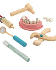 Wooden Dentist Set tools including a hammer, mirror, syringe, and teeth for children's role play.