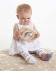 Baby exploring the Tickit Easy Hold Convex Concave Mirror on a soft rug, showcasing curious play.
