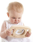 A baby exploring the Tickit Easy Hold Convex Concave Mirror with curiosity and wonder.
