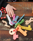 Rainbow Wooden Keys colorful wooden keys in a child's hand, perfect for playful counting and sorting activities.