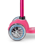 Close-up of the Mini Micro Deluxe scooter's colorful wheels and sturdy frame, built for smooth rides and play.