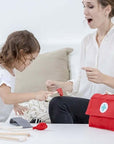 Child playing with Doctor Set, caring for an adult, fostering empathy through imaginative role-play.