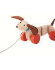 Pull Toy Dachshund Dog with cheerful face, wobbling wooden body, and fluttering fabric ears.