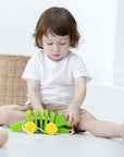 A child playing with the Pull Toy – Alligator, engaging in fun and creative exploration.