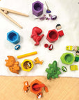 Colorful beehives set featuring wooden bees, tweezers, and playful shapes for Montessori learning and fine motor skills.