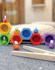 A colorful Beehives set with bees and wooden tweezers for fine motor skills and Montessori play.