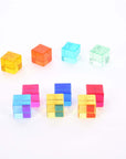 Colorful Tickit Gem Cubes arranged on a white surface, perfect for sensory play and learning activities.