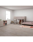 Space-saving grey bunk bed with ladder in modern child's room, featuring soft bedding and wooden accents.