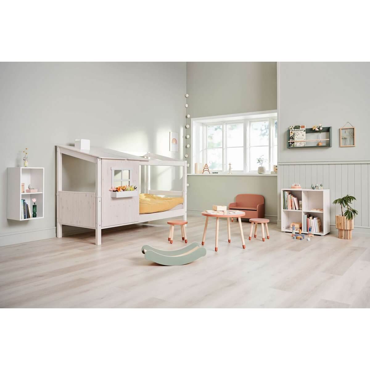 Cozy children's room with a half house bed, play area, and modern decor.