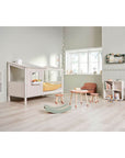 Cozy children's room with a half house bed, play area, and modern decor.