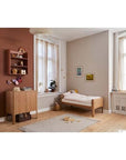 FLEXA Nova Junior Bed in oak, minimalist design, and softly rounded edges in a cozy children's bedroom.