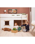 Children playing by the FLEXA Nor High Bed with Treehouse design, featuring safety rail and ladder, in a stylish bedroom.