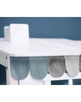Stylish fabric drape in soft hues on a white table, enhancing a playful and cozy nursery or child's room decor.