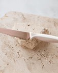 KiddiKutter Knife - Limited Edition Rose Gold on a stone surface, perfect for little cooks to use safely.
