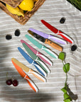 KiddiKutter Knife - Cotton Candy collection of colorful child-safe knives for little chefs on a striped cloth.