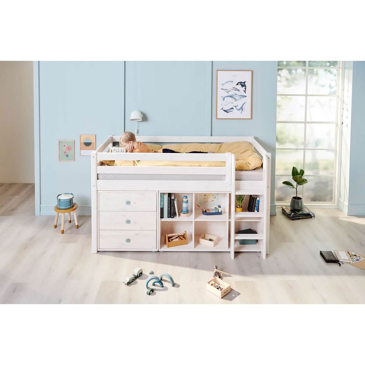 White high bed with safety rail and ladder, featuring storage underneath in a bright children&#39;s bedroom.