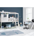 Child relaxing in a high bed with house design, featuring a ladder and play area in a cozy room with modern decor.