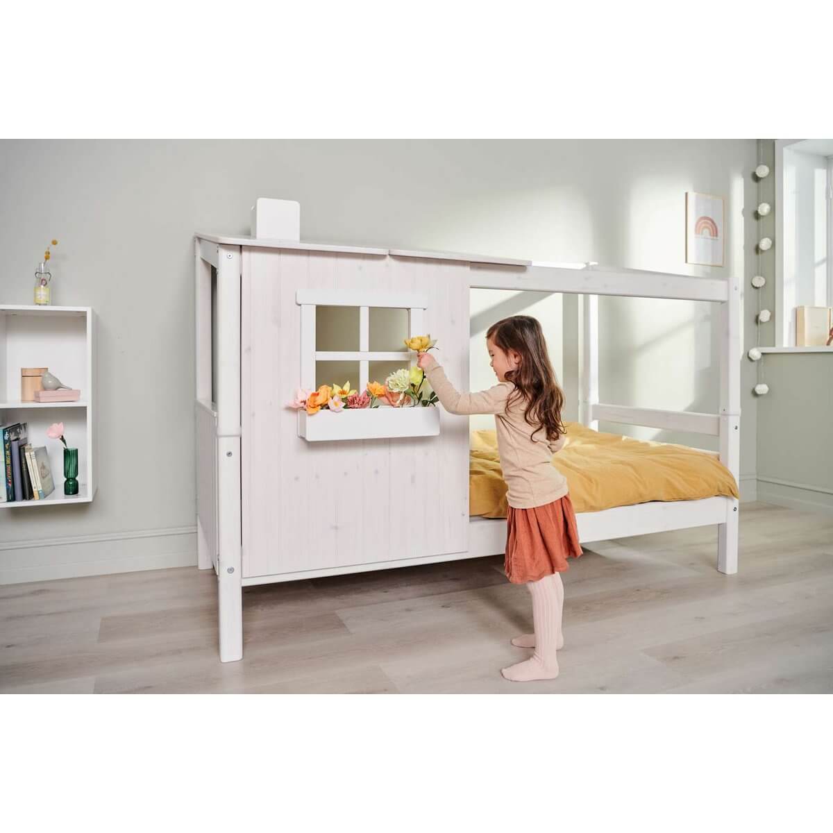 Child enjoying the FLEXA CLASSIC Half House bed, featuring a charming design and cozy window play area.